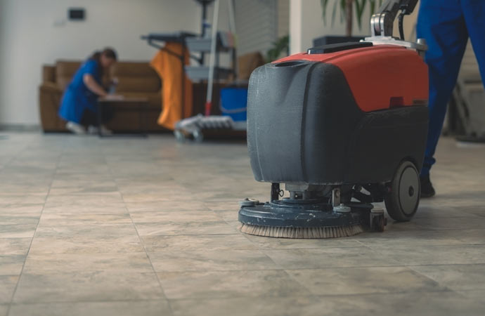 Scrubber machine efficiently cleans hard tile floors for a pristine finish.