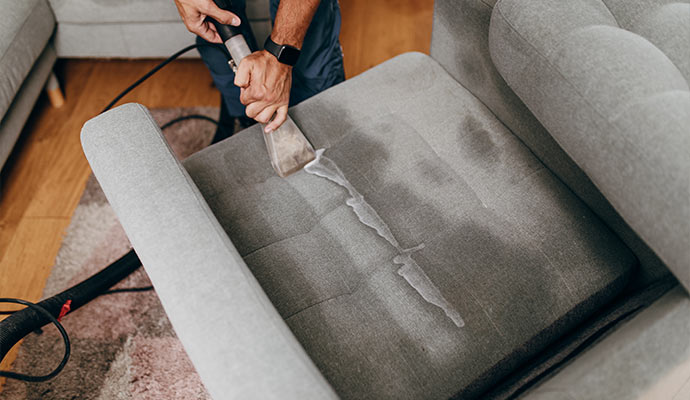 Worker cleaning polyester upholster.