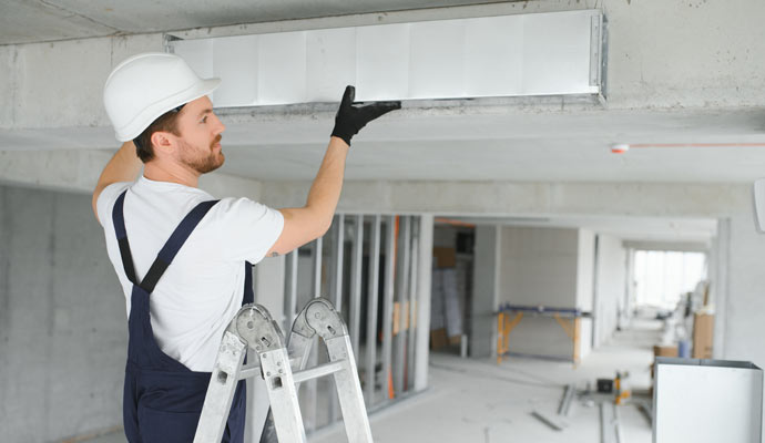 Professional worker cleaning HVAC duct