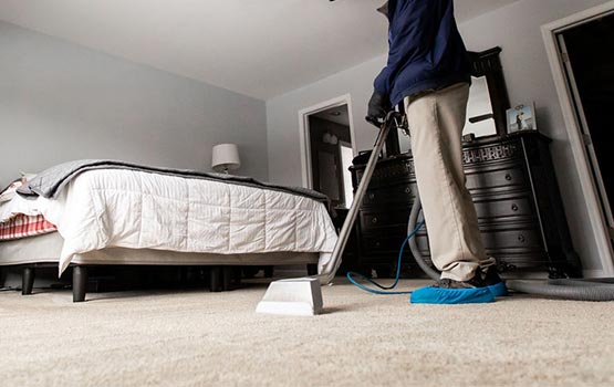 worker cleaning carpet